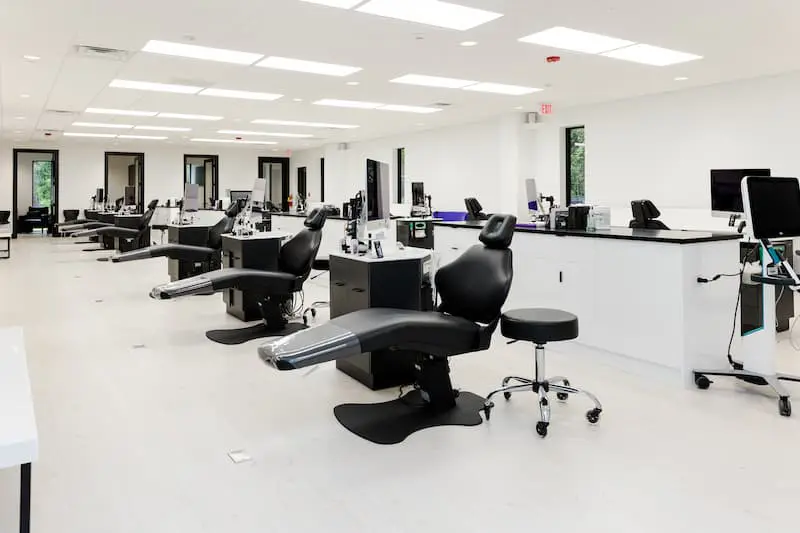 Experience our clean and modern dental clinic on an office tour, featuring multiple dental chairs, workstations, and the latest equipment in a bright, spacious room at Redemption orthodontics.