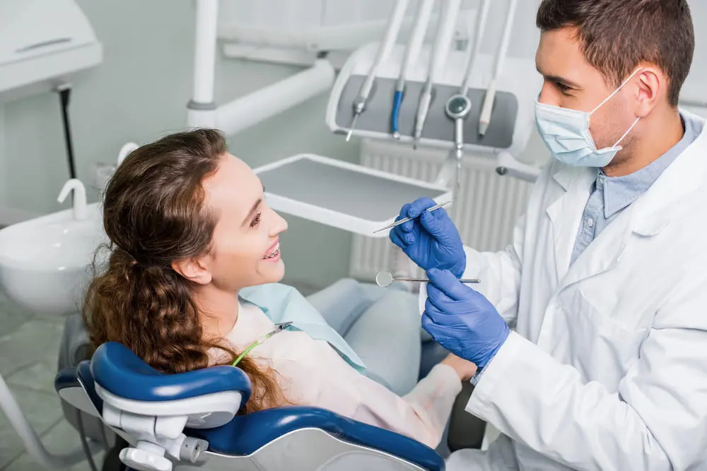 Dentist at Redemption Orthodontics in Tallahassee, FL reviews post-operative jaw surgery care with a patient.