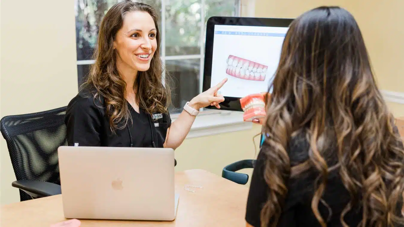 Jaw surgery consultation at Redemption Orthodontics in Tallahassee, FL, where a dental professional explains jaw surgery treatment and teeth alignment options.