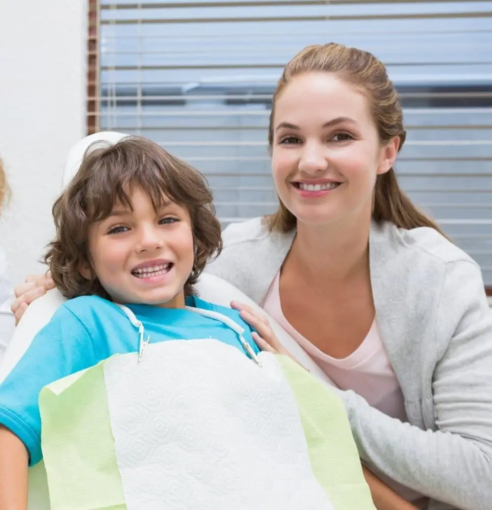 A smiling child with a dental bib sits relaxed in the chair beside a smiling her mom near orthodontic appliances at Redemption Orthodontics in Tallahassee, FL. A smiling child with a dental bib sits relaxed in the chair beside a smiling her mom near orthodontic appliances at Redemption Orthodontics in Tallahassee, FL.